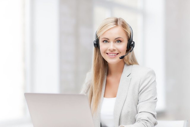 friendly female helpline operator with laptop